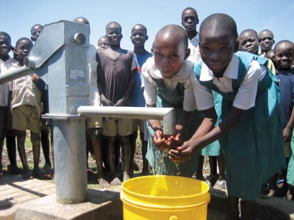 Children fetching water from a borehole. Jowtown's students have been forced to consume borehole water after the Thika water company disconnected their supply due to unpaid Shs. 2.3 Million bill. (Photo/VMwenda)