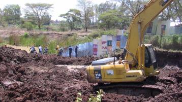 The earthmoving machine which had started works on the allegedly grabbed land.